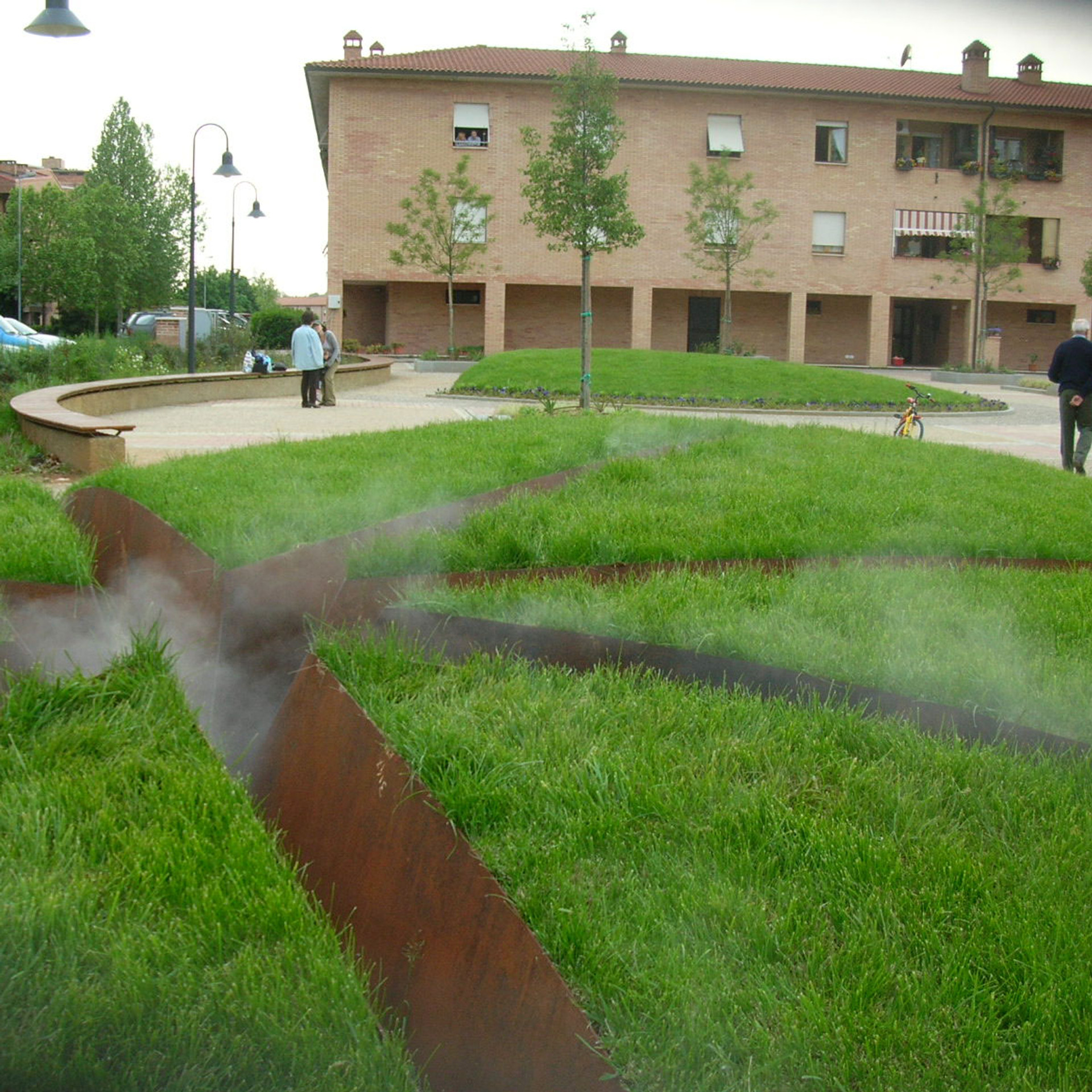 Corten steel water channels in lawn with mist effects